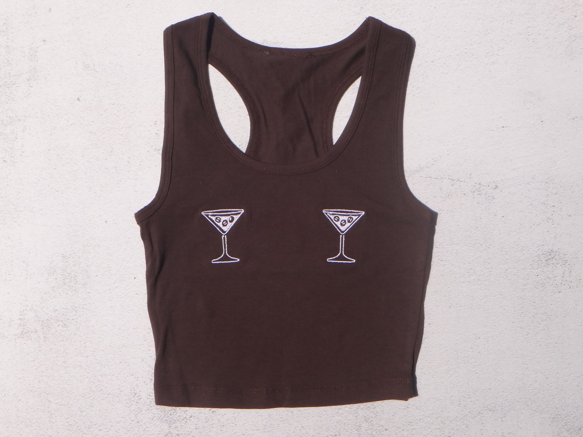 Brown tank top with martini glass designs on a light gray background